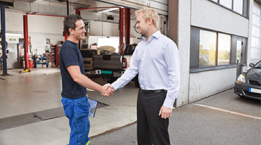 satisfied customer shaking hands with technician